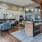 a kitchen with a bar and chairs