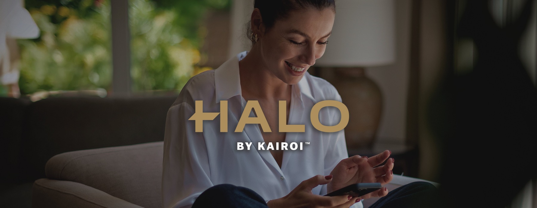 a woman smiling and interacting with her device