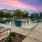 a pool with benches and a building in the background