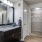Modern bathroom with closet at Landmark Conservancy Bee Cave, TX apartments.